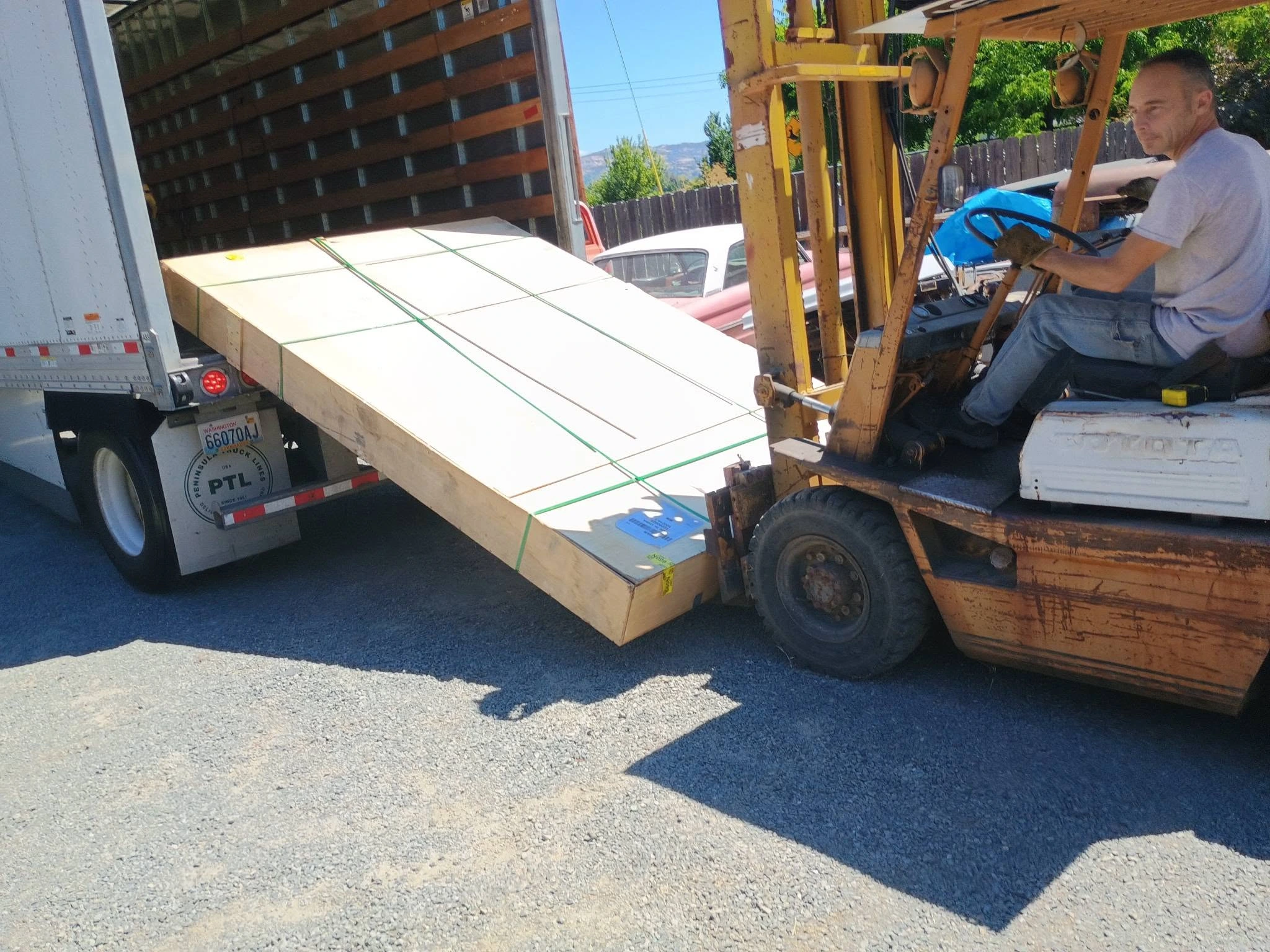 A KOVR crate unloaded from a delivery truck with a forklift